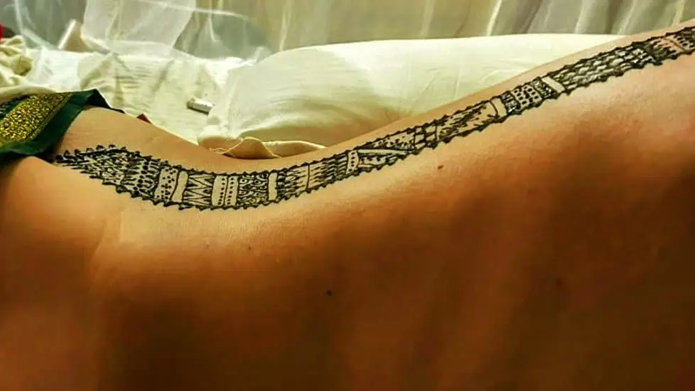 Henna adorns the back of a participant in Realistiq Mystiq's signature Tantric Experience session in South Goa.