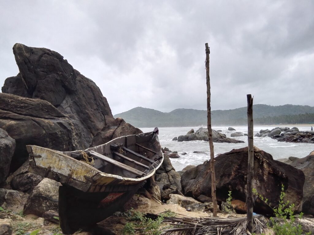 Fear, Dressed as Principle Wrecked wooden boat against rocks on a stormy Goa beach